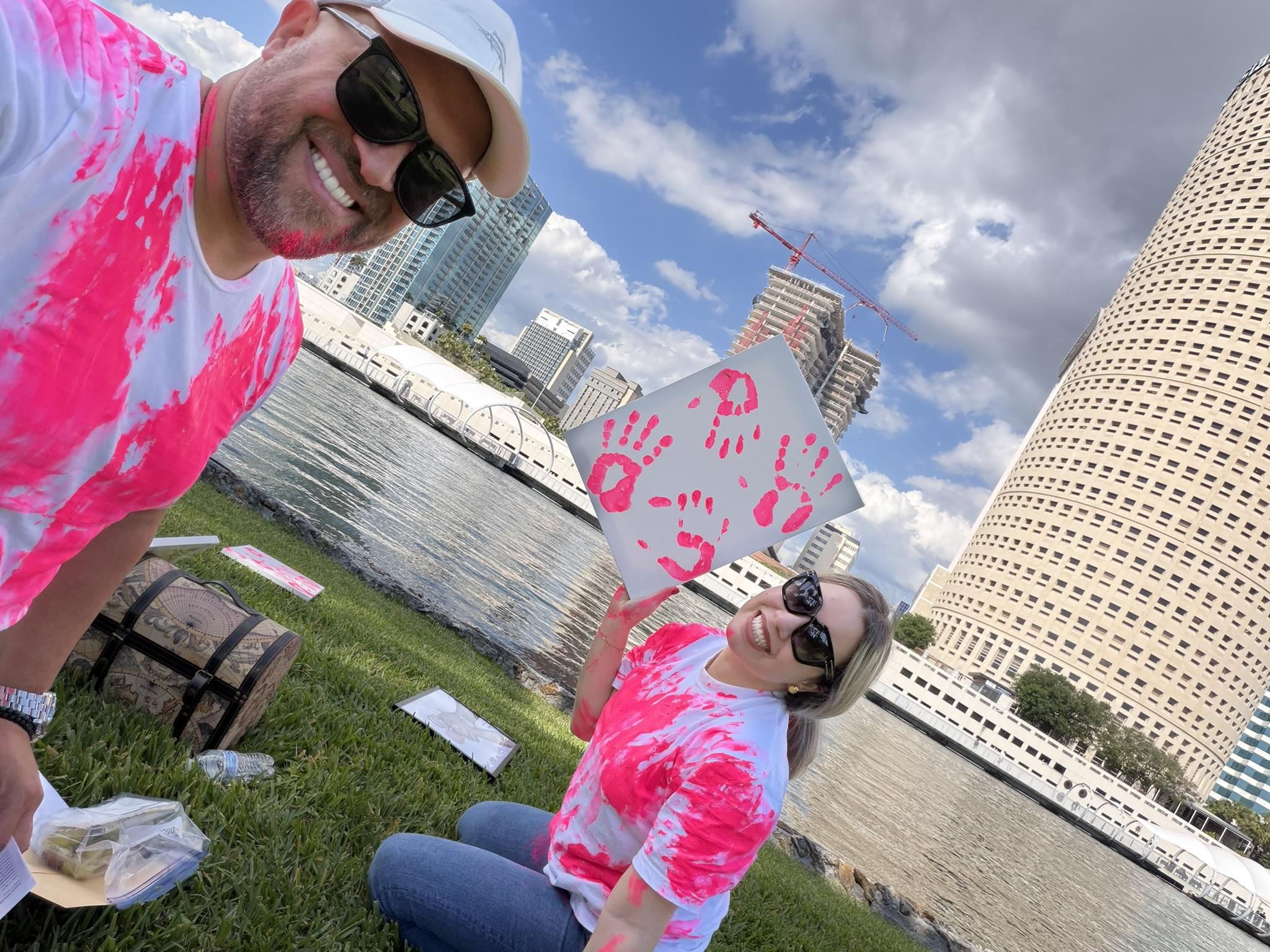 Elizabeth and Joshua celebrating their baby girl gender reveal along the Tampa waterfront